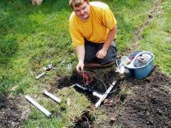 one of our St. Catharines irrigation repair techs is fixing a broken valve